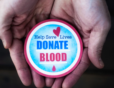 Donate Blood sticker in two cupped hands 