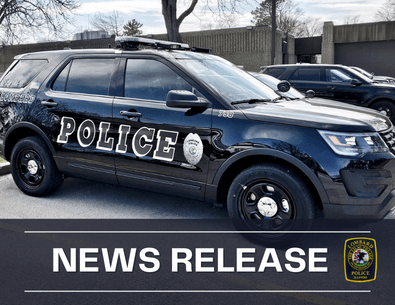 Black Lombard Police squad car in parking lot with text