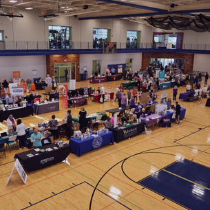 photo of last year's senior fair from overhead showing seniors walking throughout the event space