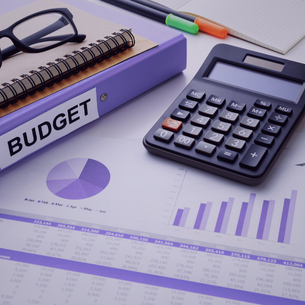 photo of binder with budget title and sheets with graphs and calculations